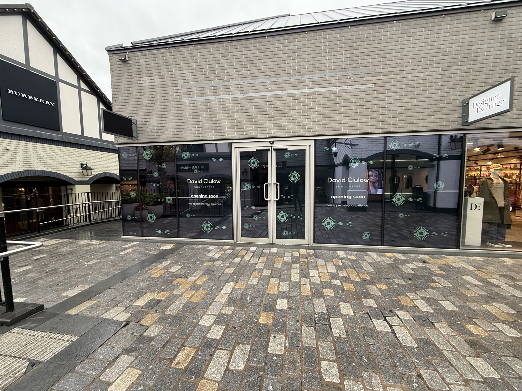 Applied vinyl lettering and patterned graphics on a shop window